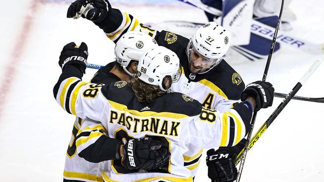Boston Bruins' Jake DeBrusk, left, celebrates his goal with Joakim