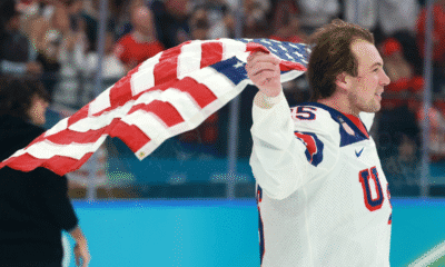Charlie McAvoy (Bruins) skates with a USA flag after beating Canada 2-1 in the gold medal game